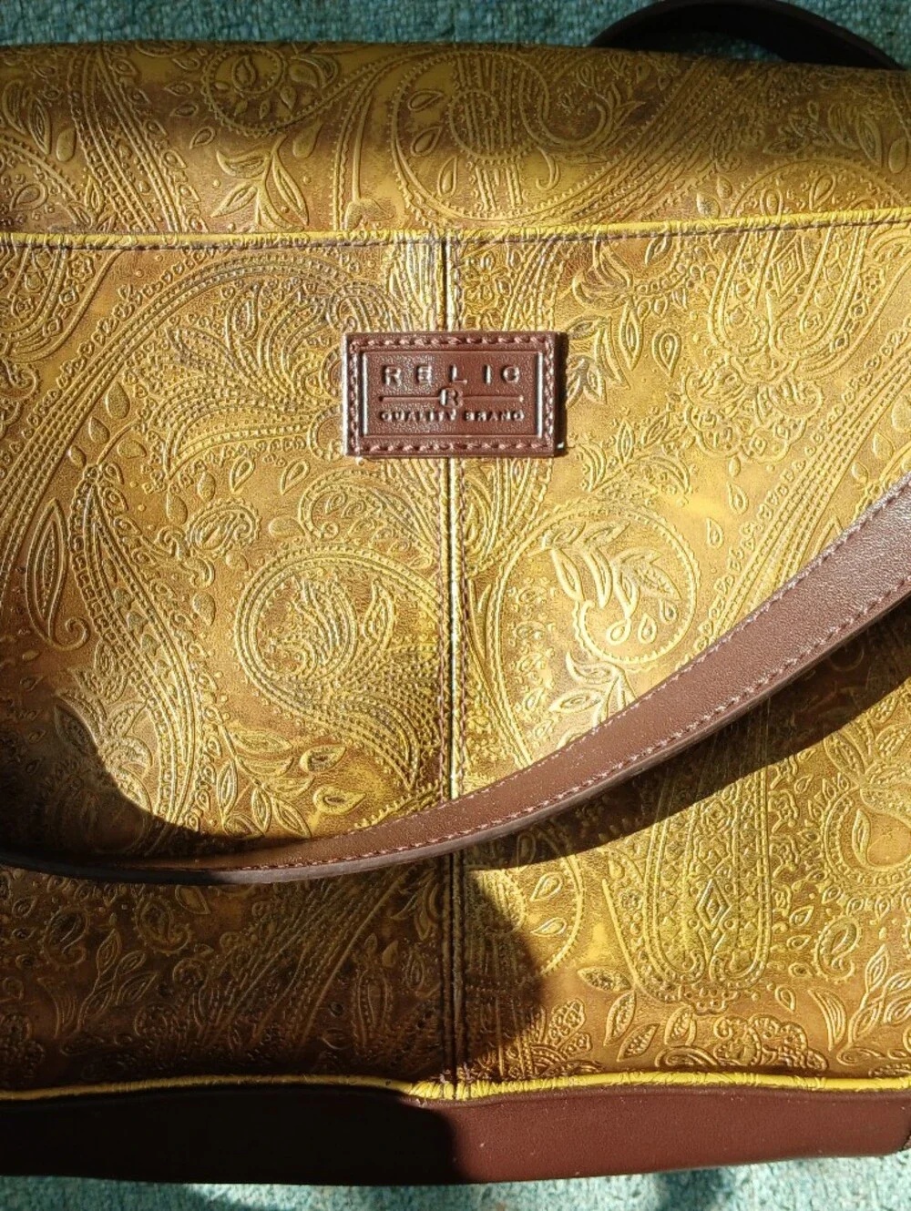 Relic Embossed Leather Crossbody Bag in Gold